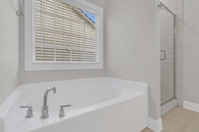 bathroom featuring tile patterned flooring and shower with separate bathtub
