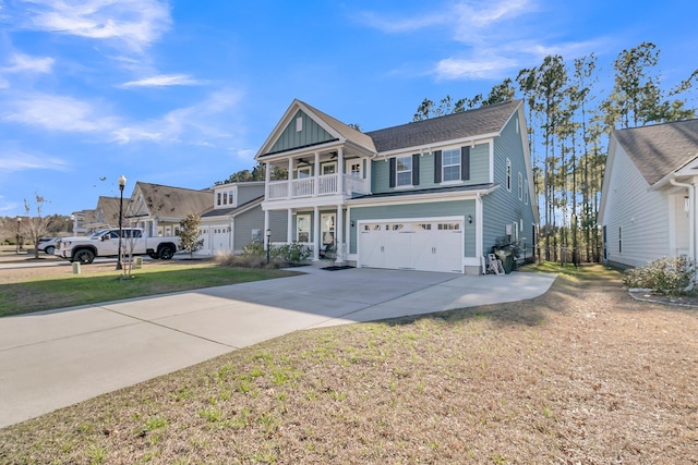 view of front of property featuring a garage, a balcony, and a front yard
