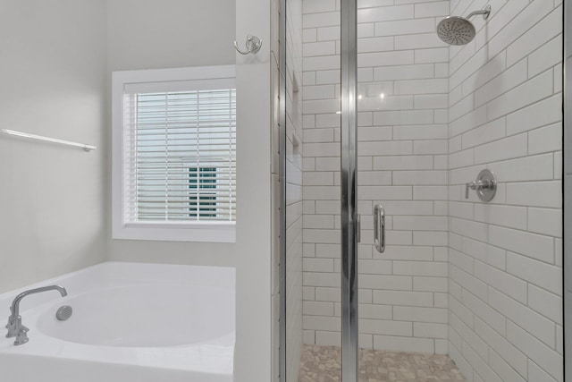 bathroom with shower with separate bathtub