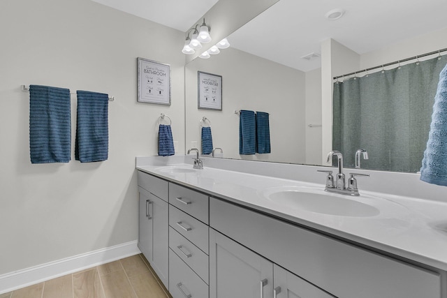 bathroom with hardwood / wood-style flooring and vanity