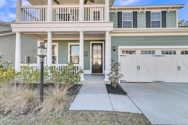 doorway to property with a garage and a porch