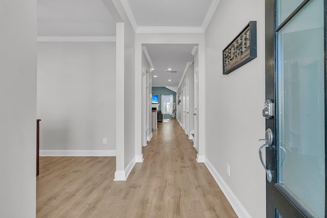 corridor featuring crown molding and light hardwood / wood-style flooring