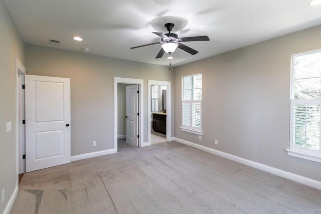 225 Slipper Shell Ct, Mount Pleasant, SC 29464 - unfurnished bedroom with light colored carpet, multiple windows, baseboards, connected bathroom, and recessed lighting