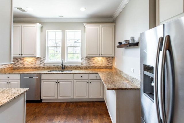 225 Slipper Shell Ct, Mount Pleasant, SC 29464 - kitchen with appliances with stainless steel finishes, a sink, crown molding, decorative backsplash, and light stone countertops