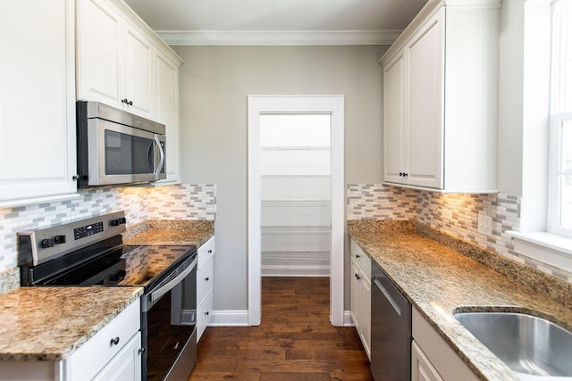 225 Slipper Shell Ct, Mount Pleasant, SC 29464 - kitchen featuring appliances with stainless steel finishes, crown molding, dark wood finished floors, light stone counters, and white cabinetry