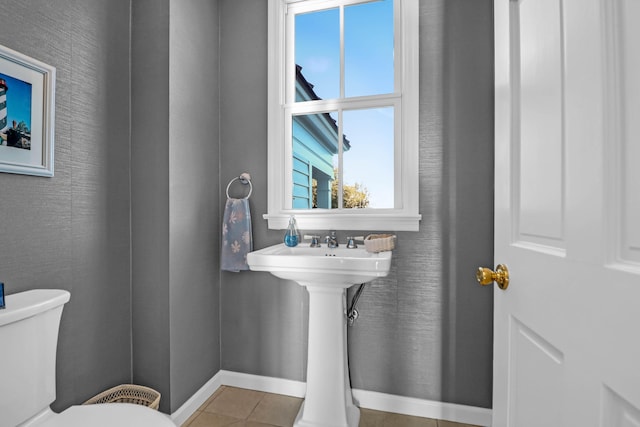 bathroom featuring tile patterned flooring and toilet