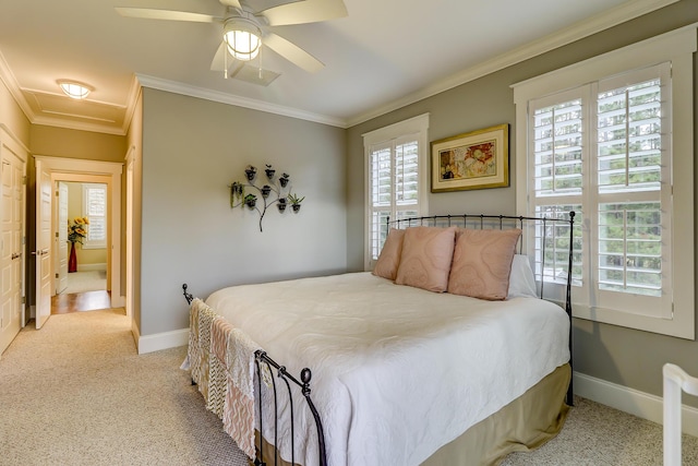 carpeted bedroom with attic access, a ceiling fan, baseboards, and ornamental molding