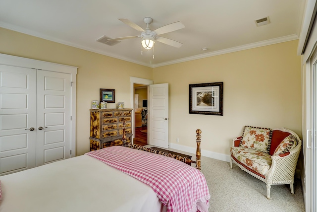 carpeted bedroom with baseboards, visible vents, a closet, and ornamental molding