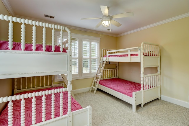 bedroom featuring visible vents, baseboards, carpet floors, ornamental molding, and a ceiling fan