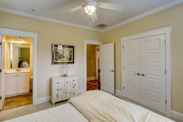 bedroom with a closet, baseboards, visible vents, and crown molding