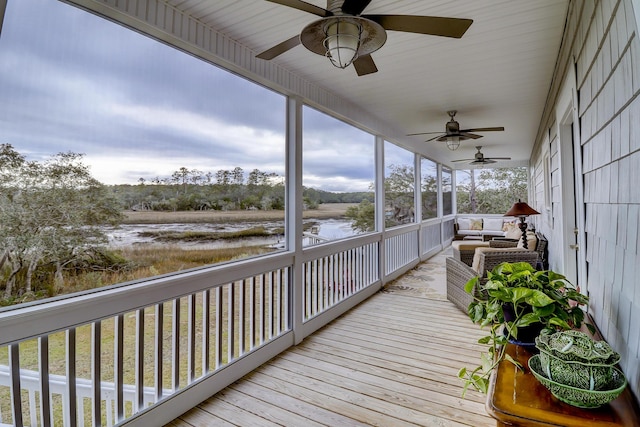 wooden terrace featuring ceiling fan