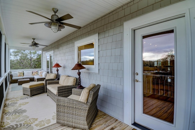 sunroom / solarium featuring ceiling fan