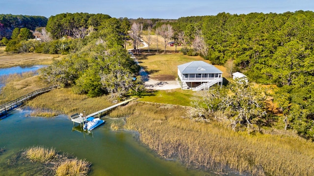 bird's eye view with a forest view and a water view