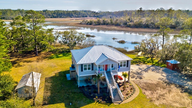 bird's eye view featuring a forest view and a water view