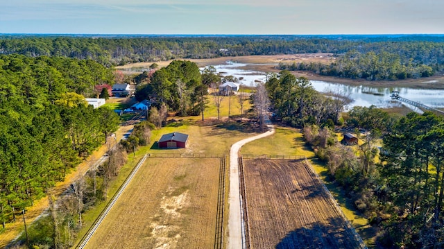 birds eye view of property with a forest view and a water view