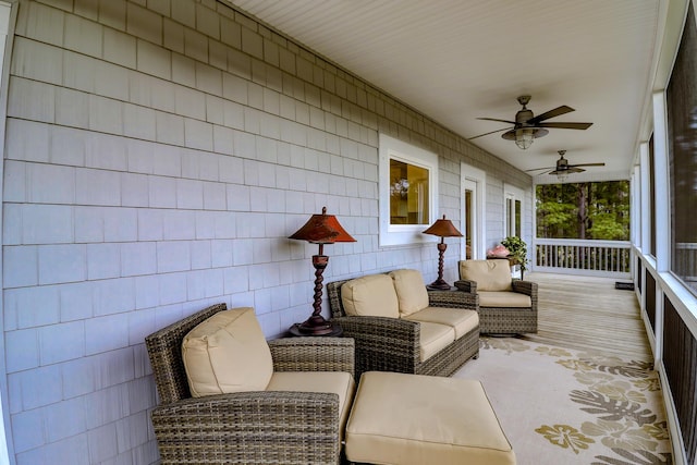 wooden deck featuring covered porch and a ceiling fan