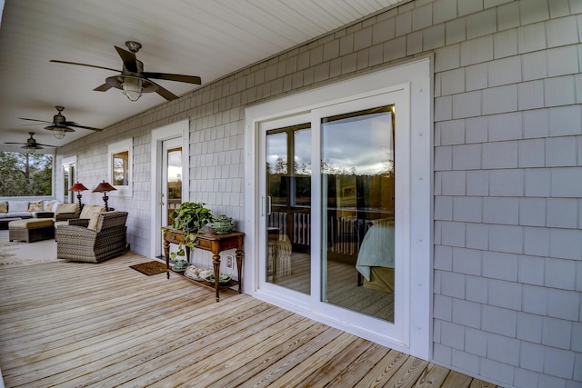 wooden deck featuring a ceiling fan