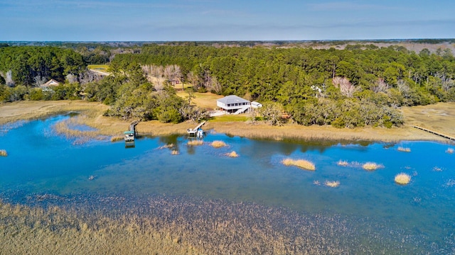 aerial view with a wooded view and a water view