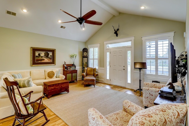 living area featuring visible vents, plenty of natural light, and wood finished floors