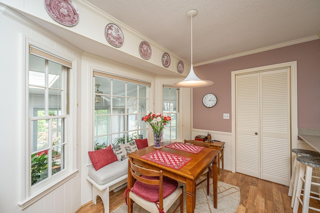 206 Brailsford Rd, Summerville, SC 29485 - dining space with wainscoting, crown molding, a textured ceiling, and light wood-type flooring
