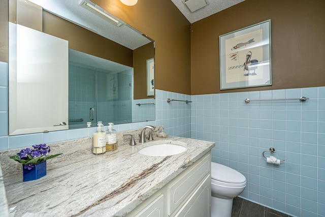 206 Brailsford Rd, Summerville, SC 29485 - bathroom with a stall shower, wainscoting, vanity, tile walls, and toilet