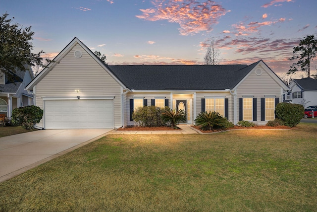 ranch-style home with an attached garage, a yard, driveway, and roof with shingles