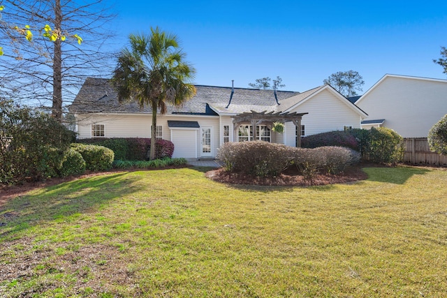 ranch-style house featuring fence, a shingled roof, a front yard, and a pergola