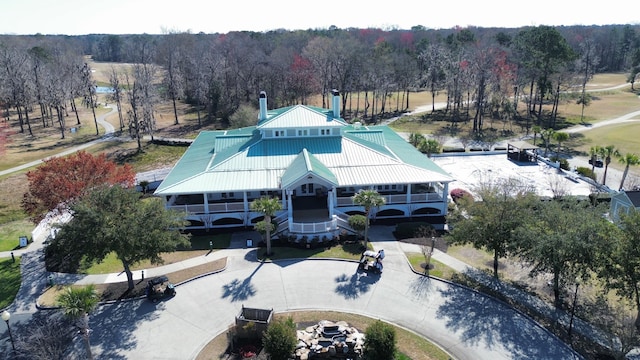 drone / aerial view featuring a wooded view