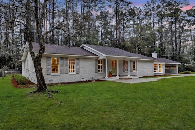 ranch-style home with crawl space, a yard, and brick siding