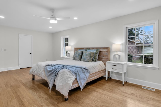 bedroom with a ceiling fan, visible vents, baseboards, light wood finished floors, and recessed lighting