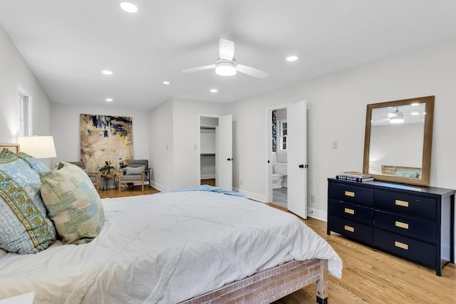 bedroom with a ceiling fan, baseboards, recessed lighting, a spacious closet, and light wood-style floors