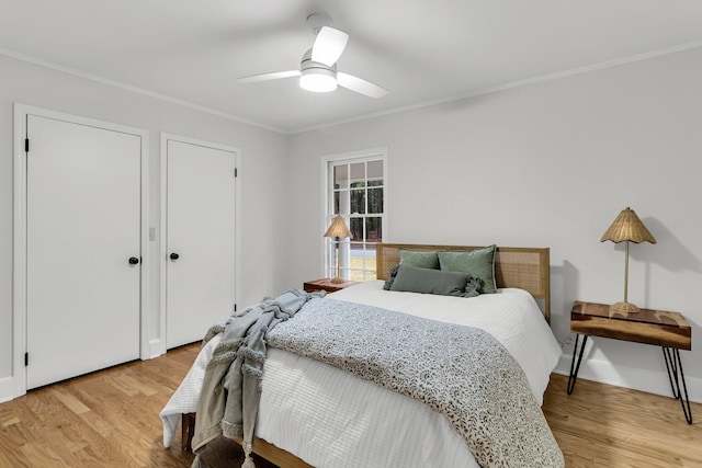 bedroom featuring crown molding, light wood-style floors, and ceiling fan