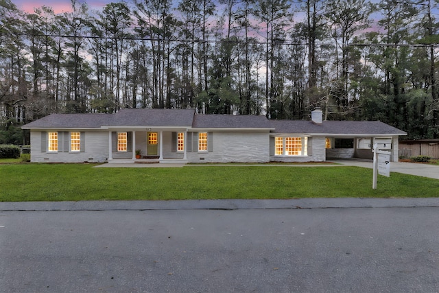 ranch-style home featuring a shingled roof, a front lawn, concrete driveway, a garage, and crawl space