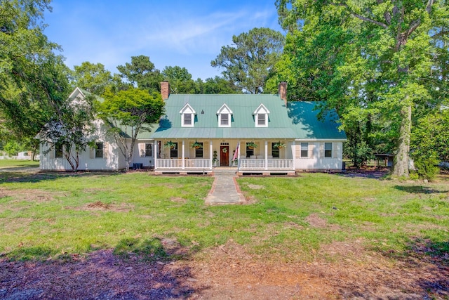 481 Cantey Ln, Camden, SC 29020 - cape cod house featuring covered porch, a chimney, a front lawn, and metal roof