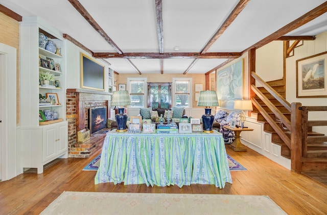 481 Cantey Ln, Camden, SC 29020 - living area with hardwood / wood-style flooring, stairs, beam ceiling, a fireplace, and built in shelves