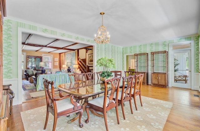 481 Cantey Ln, Camden, SC 29020 - dining space featuring wallpapered walls, a chandelier, light wood-style flooring, wainscoting, and crown molding