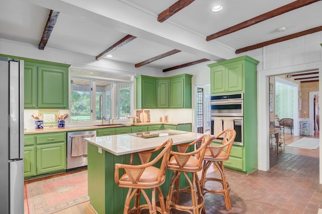 481 Cantey Ln, Camden, SC 29020 - kitchen with stainless steel appliances, a sink, green cabinetry, beam ceiling, and a kitchen island