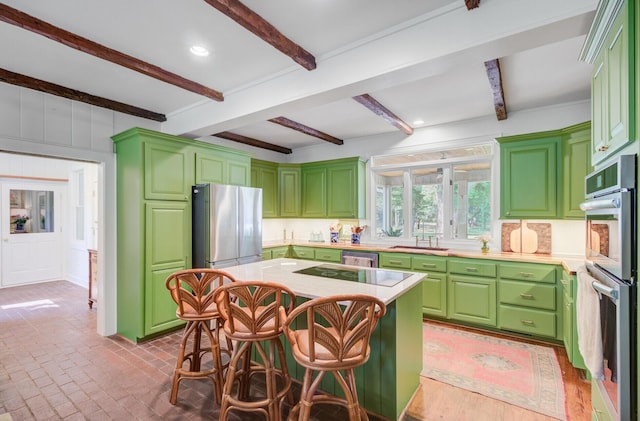 481 Cantey Ln, Camden, SC 29020 - kitchen featuring stainless steel appliances, a sink, a decorative wall, light countertops, and a breakfast bar