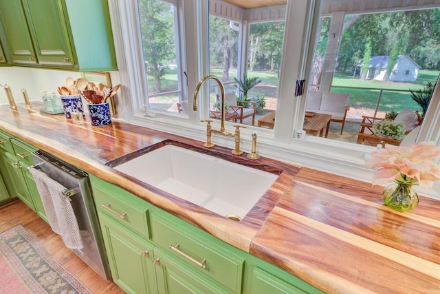 481 Cantey Ln, Camden, SC 29020 - kitchen featuring green cabinets, a sink, butcher block counters, stainless steel dishwasher, and light wood-style flooring