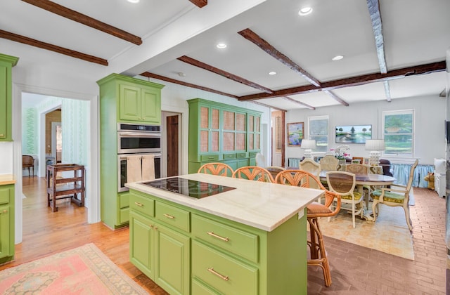 481 Cantey Ln, Camden, SC 29020 - kitchen with green cabinetry, black electric cooktop, a breakfast bar, light countertops, and beam ceiling