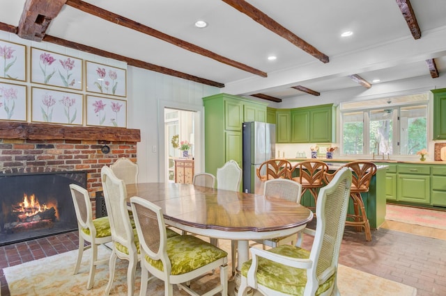 481 Cantey Ln, Camden, SC 29020 - dining room featuring brick floors, beamed ceiling, a brick fireplace, and recessed lighting