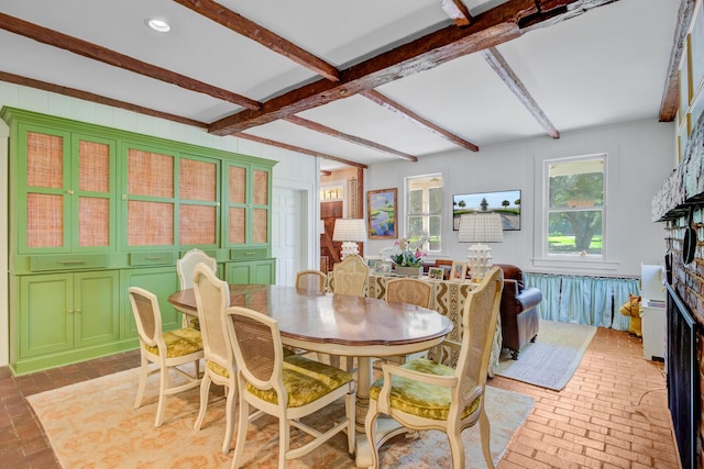481 Cantey Ln, Camden, SC 29020 - dining space with brick flooring, beamed ceiling, and a fireplace