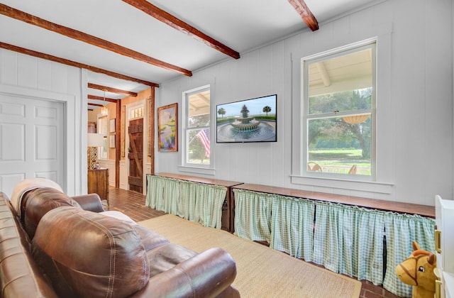 481 Cantey Ln, Camden, SC 29020 - living area with beam ceiling, a decorative wall, and brick patterned floors