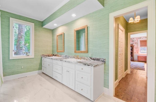 481 Cantey Ln, Camden, SC 29020 - bathroom featuring double vanity, baseboards, a chandelier, and wallpapered walls