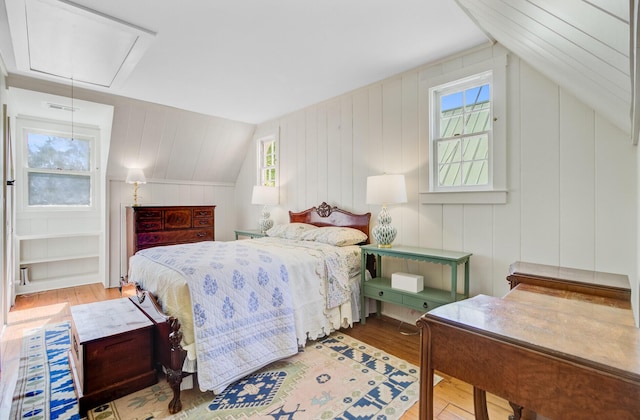 481 Cantey Ln, Camden, SC 29020 - bedroom with attic access, multiple windows, wood finished floors, and lofted ceiling
