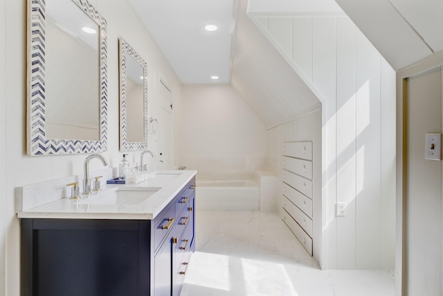 481 Cantey Ln, Camden, SC 29020 - full bathroom with double vanity, a garden tub, recessed lighting, and lofted ceiling