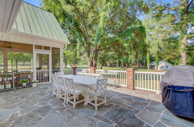 481 Cantey Ln, Camden, SC 29020 - view of patio featuring outdoor dining space, a grill, view of wooded area, and a sunroom