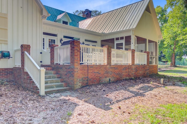 481 Cantey Ln, Camden, SC 29020 - view of side of property featuring a sunroom, a chimney, metal roof, and a standing seam roof