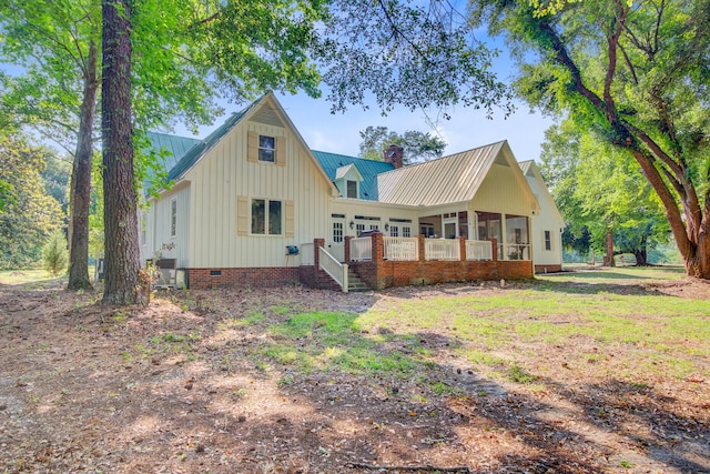 481 Cantey Ln, Camden, SC 29020 - view of front facade featuring a chimney, crawl space, a sunroom, metal roof, and board and batten siding
