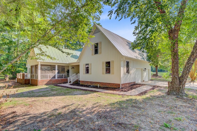481 Cantey Ln, Camden, SC 29020 - view of front of house featuring metal roof, a sunroom, an attached garage, and driveway